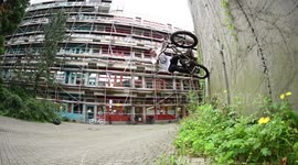 BMX Biker jumps up to a wall and back