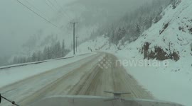 Driving a big rig down a steep, snow covered mountain grade in British Columbia, Canada.