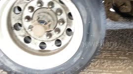 Hauling giant mining tyres in winter with a semi truck trailer in North America