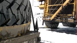 Hauling giant mining tyres in winter with a semi truck trailer in North America