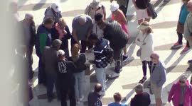 Clip of pea men, potato men or three shell con artists working the crowd, filmed from above.