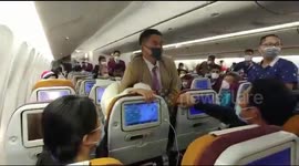 Thai Airways cabin crew wrestle Chinese passenger into her seat after she 'deliberately COUGHED at them'