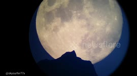 Moon rise behind a mountain