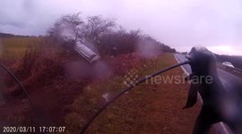 Terrifying footage shows speeding car narrowly avoid cyclist and swerve into tree off UK motorway