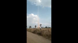Huge dust devil swirls through Thai famer's field