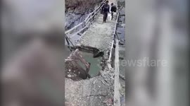Man risks his life, precariously walks across damaged bridge to carry things in northern India