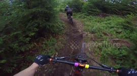 Mountain bike rider goes over the bar in bikepark Szczyrk