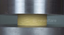 Hydraulic press completely flattens rolls of household tape