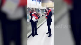 US violinists serenade empty toilet roll shelves with 'Titanic' hymn