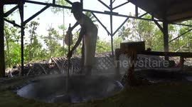 Men breath in poisonous fumes as they work in a sulphur processing factory deep in the jungles of East Java, Indonesia