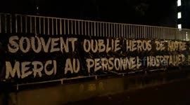 Parisians in lockdown take to balconies and windows to applaud health workers
