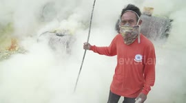 Indonesian miners work in clouds of poisonous gas as they mine sulphur from volcano crater