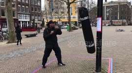 Amsterdam residents take out 'corona frustration' on punchbags in the streets