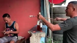 Friends use glass on stick to follow social distancing guideline at drinking session