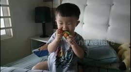 Greedy toddler sucks both two pacifiers at one time