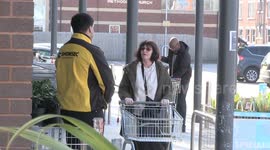 Security at UK supermarket doors help contain shoppers and stop panic buying