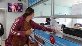 Utilities company uses fishing nets for social distancing while collecting payment from customers