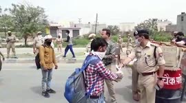Thousands of homebound daily wage labourers flee Delhi on foot amid nationwide lockdown, rescued by police personnel in northern India