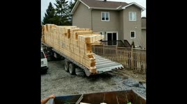 Roof frame slides satisfyingly off back of truck on building site