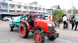 Thai farmers use tractors to spray streets with sanitising liquid during coronavirus pandemic