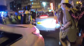 Hong Kong Riot police attempt arrest of a woman, give up when surrounded by press