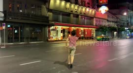 Street food vendor plays badminton on once-busy China Town in Bangkok