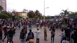 People protesting outside the commercial center guarded by the military, raise their hands to special forces