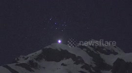 Bright planet Venus setting behind the Swiss Alps