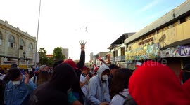 People protesting and throwing candy into the air