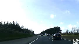 bad driver almost crashes on Edinburgh bypass on a mobile phone