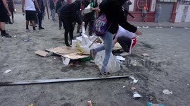 People lighting a bonfire while waiting to confront the military and special forces in Chile