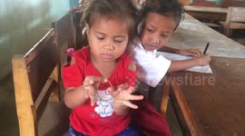 a little girl try to teach you how to play rubber