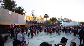 People jumping in the protest with screams and songs in the main square of the city