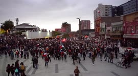 People turning on the light of their cell phones after the march in the main square of the city