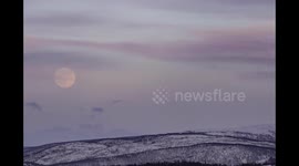 Watch as the April super-moon rises above the snow capped hills of Norway