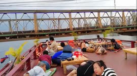 Mind your head! Cambodian diners duck on river cruise to avoid low bridge