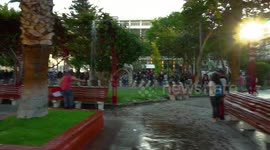 Large number of people in the center protesting, a cathedral painted with slogans