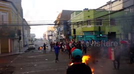 Protesters in the city center singing with bonfires and destroyed administrative buildings