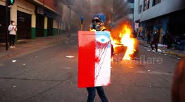 Protesters in the city center singing with bonfires and destroyed administrative buildings