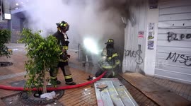 Fire in bank as a result of violent protests, firefighters in action