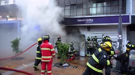 Fire in bank as a result of violent protests, firefighters in action