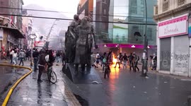 People fleeing tear gas launched by special forces, amid protests