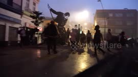 Hooded people looting a shop in the city center after the protests, some shops destroyed and others burned down
