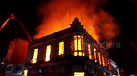 Old 1912 building on fire after the protests, one of the oldest in the city, firefighters in action