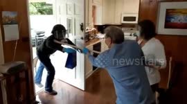 US family pass over birthday presents using stick during COVID-19 quarantine