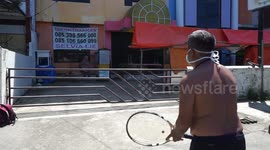Husband and Wife in Makassar Play Tennis in Front of the Empty Building during the Coronavirus Outbreak