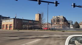 Firefighter practicing, playing or cleaning parking lot with high pressure water?