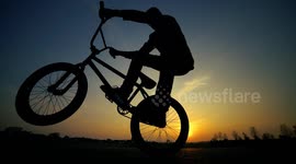 Lovely Sunset & BMX Action Athlete from Youtube Channel woozyBMX doing wheelie tricks