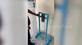 Thai worker creates device for people to press hand sanitiser bottle with feet during coronavirus pandemic
