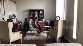 Adorable moment young cellist and French bulldog warm-up together amid coronavirus lockdown